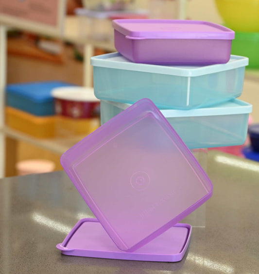 Stack of colorful plastic containers on a table